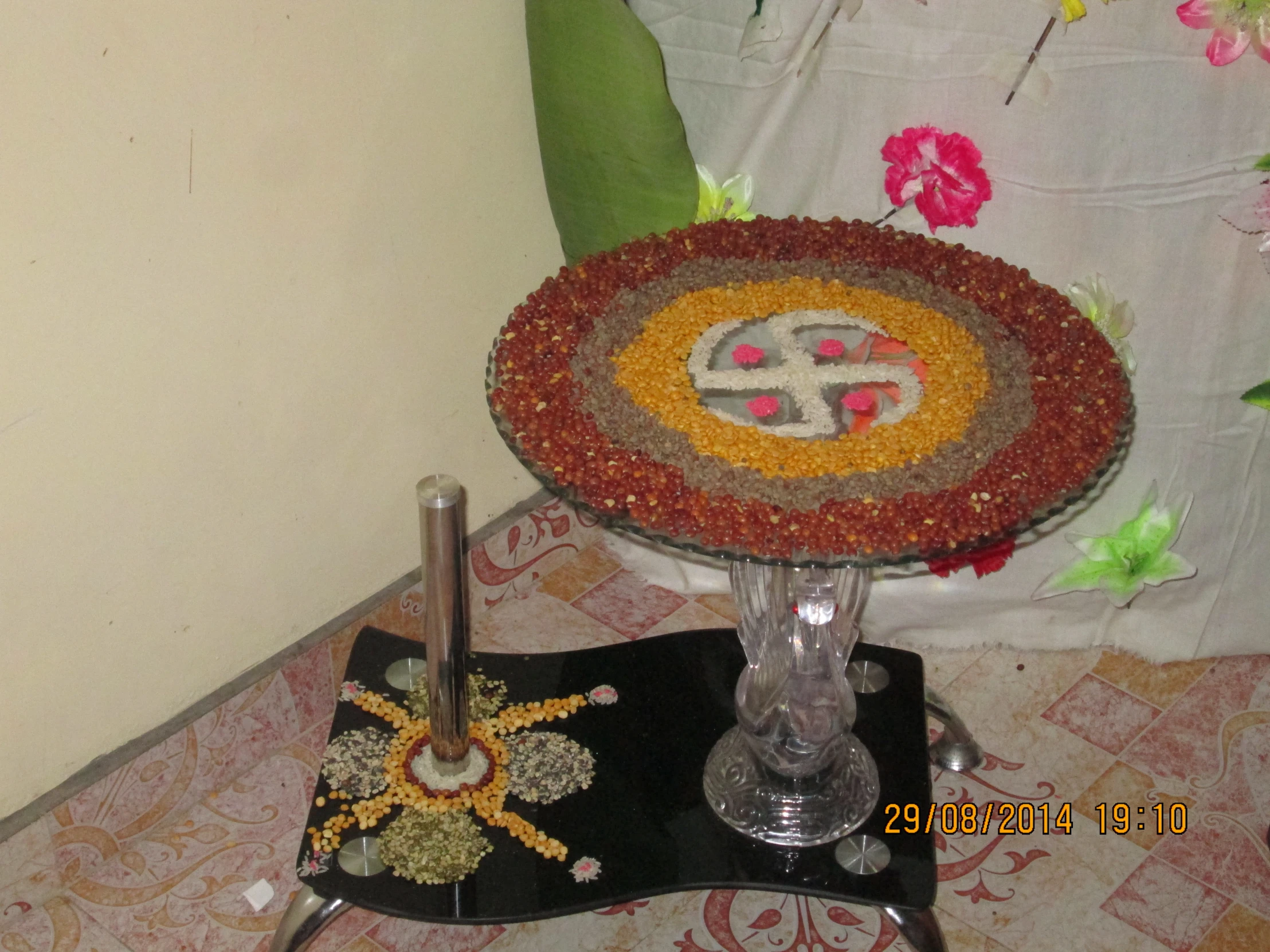 two fancy flower decorations on a glass pedestal