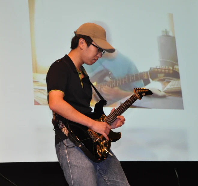 a person standing with a guitar in their hands