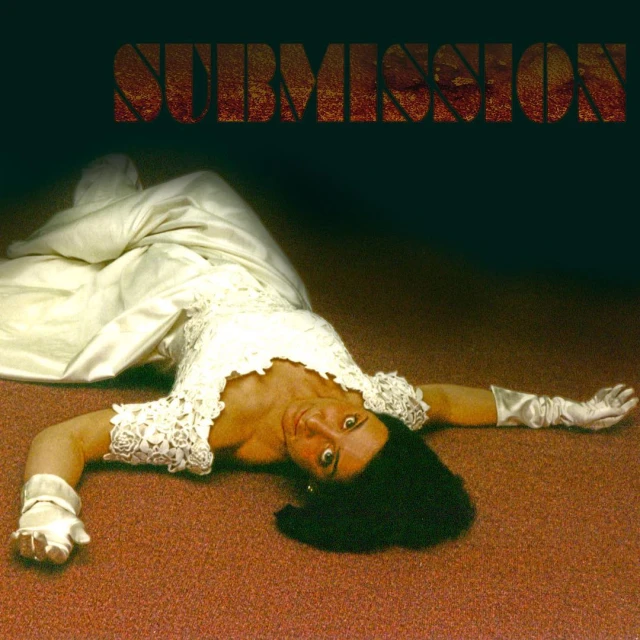 a woman in white is laying on the floor with a long sleeved shirt and wide brimmed pants