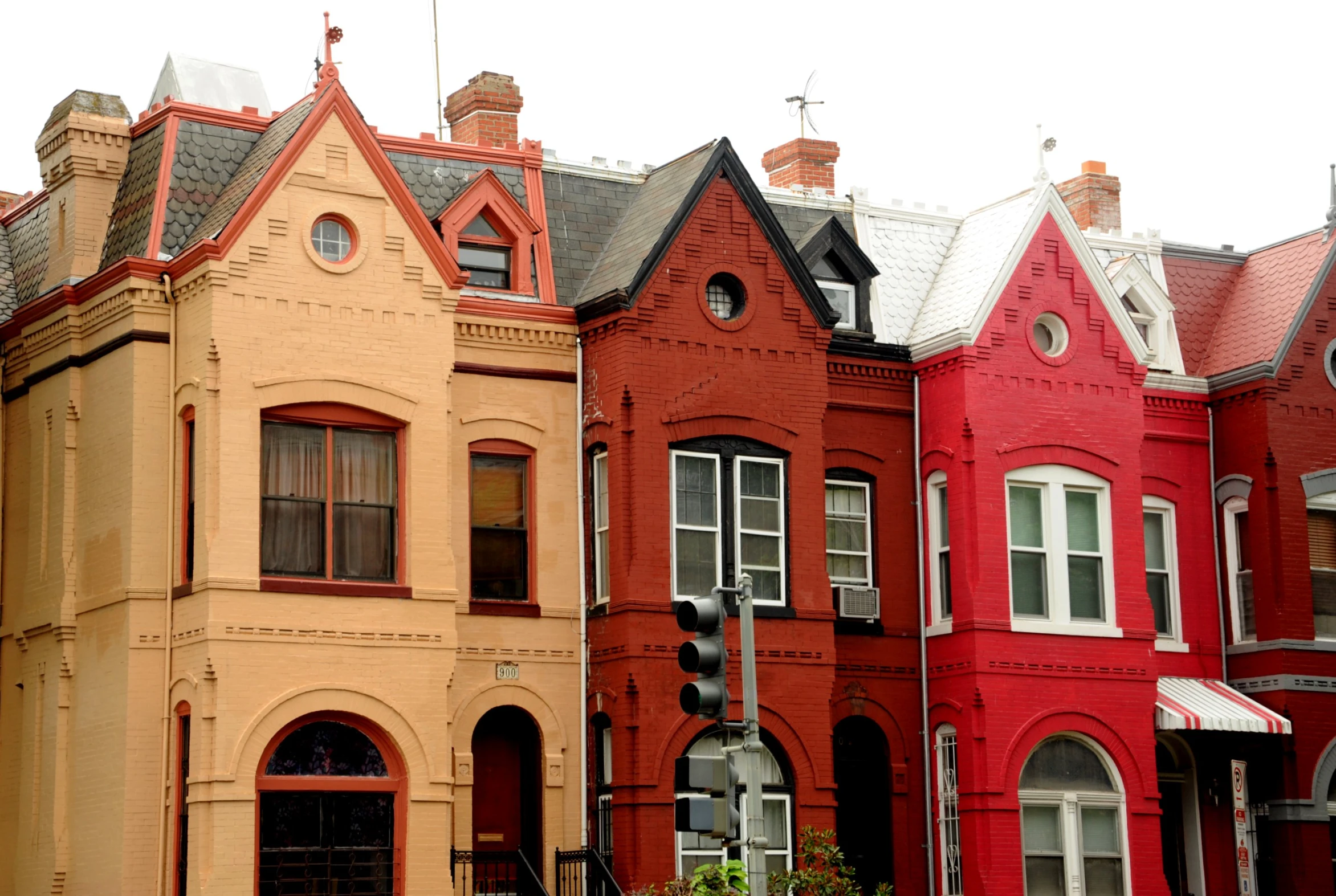 a row of old - fashioned red brick houses with rooftop tops