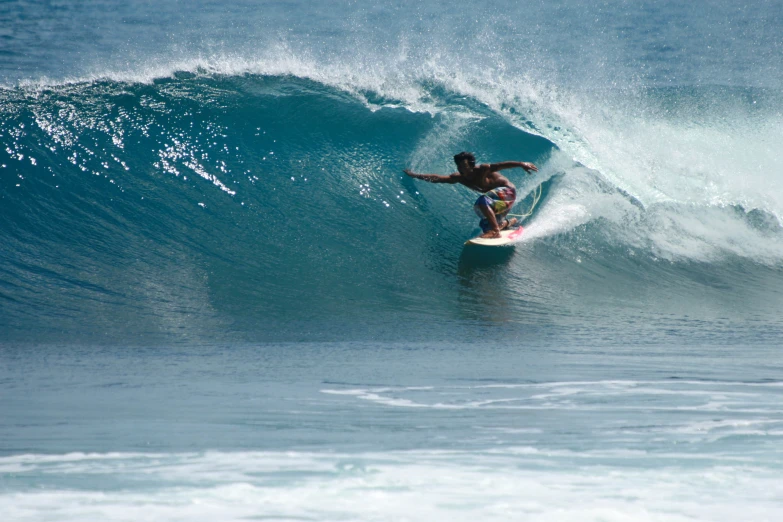 a man surfing on a wave with large white sprays