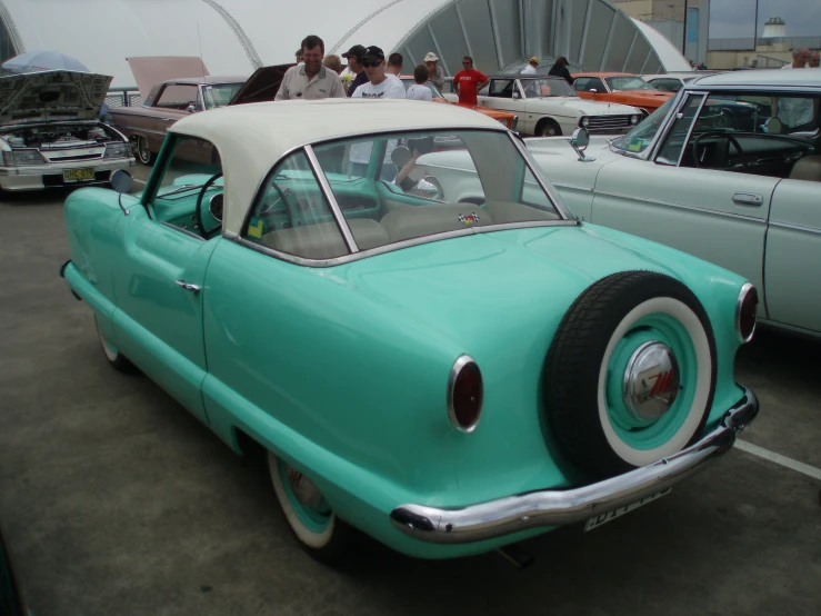 a blue car sits in the parking lot