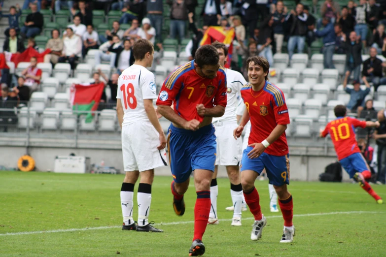 soccer players from opposing teams on the field