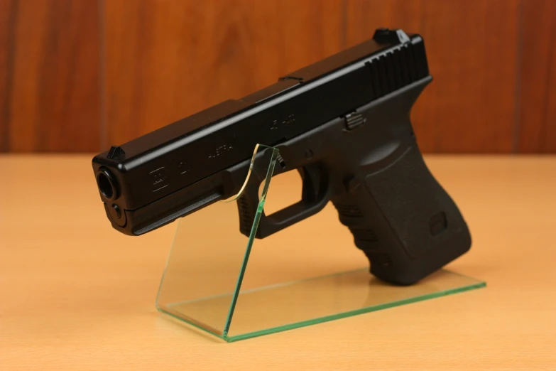 the black gun has been placed on the clear plate