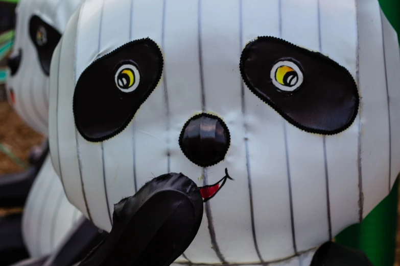 a fake panda bear wearing a baseball uniform and hat