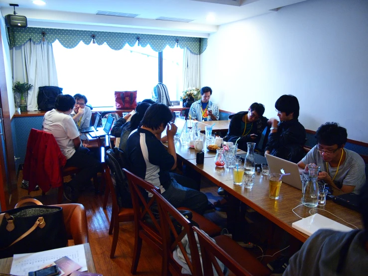 people sitting around a table in a restaurant