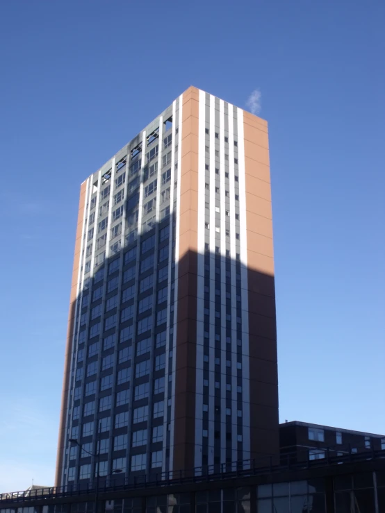 a large tall building sitting in front of a blue sky