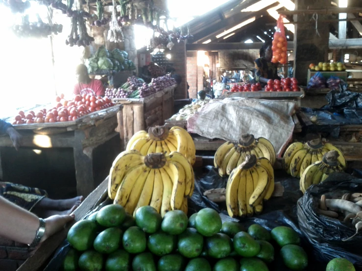 the fruit stand has several bunches of bananas on display