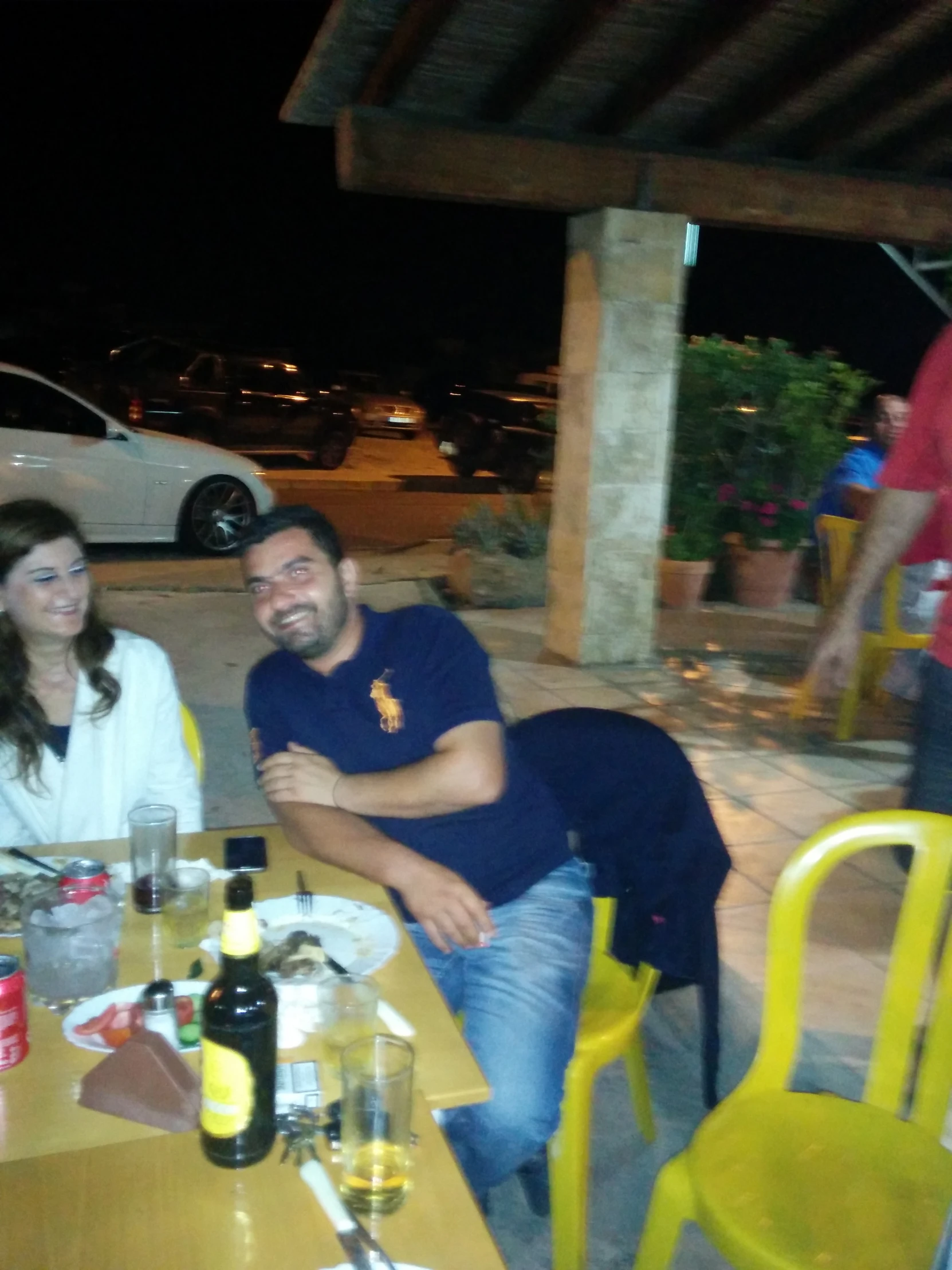 two people sitting at a table smiling for the camera