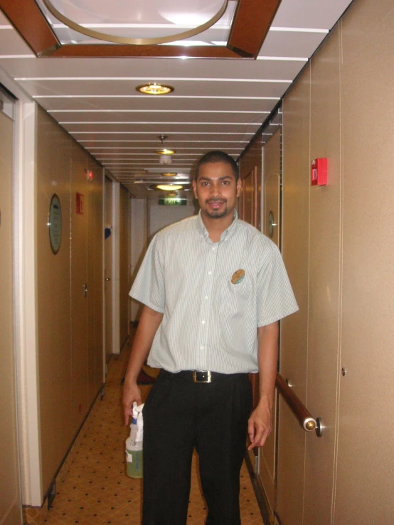 a man is standing in the hallway with his feet propped up
