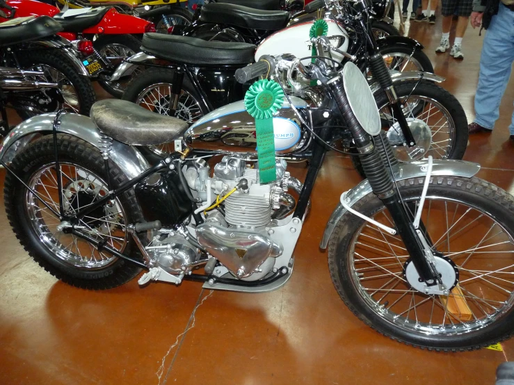 a row of parked motor bikes on display