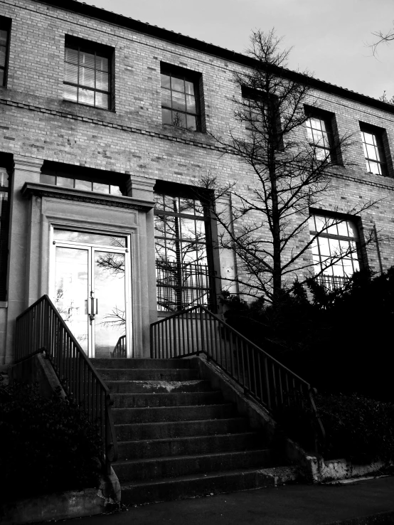 a black and white po of a staircase next to an apartment building