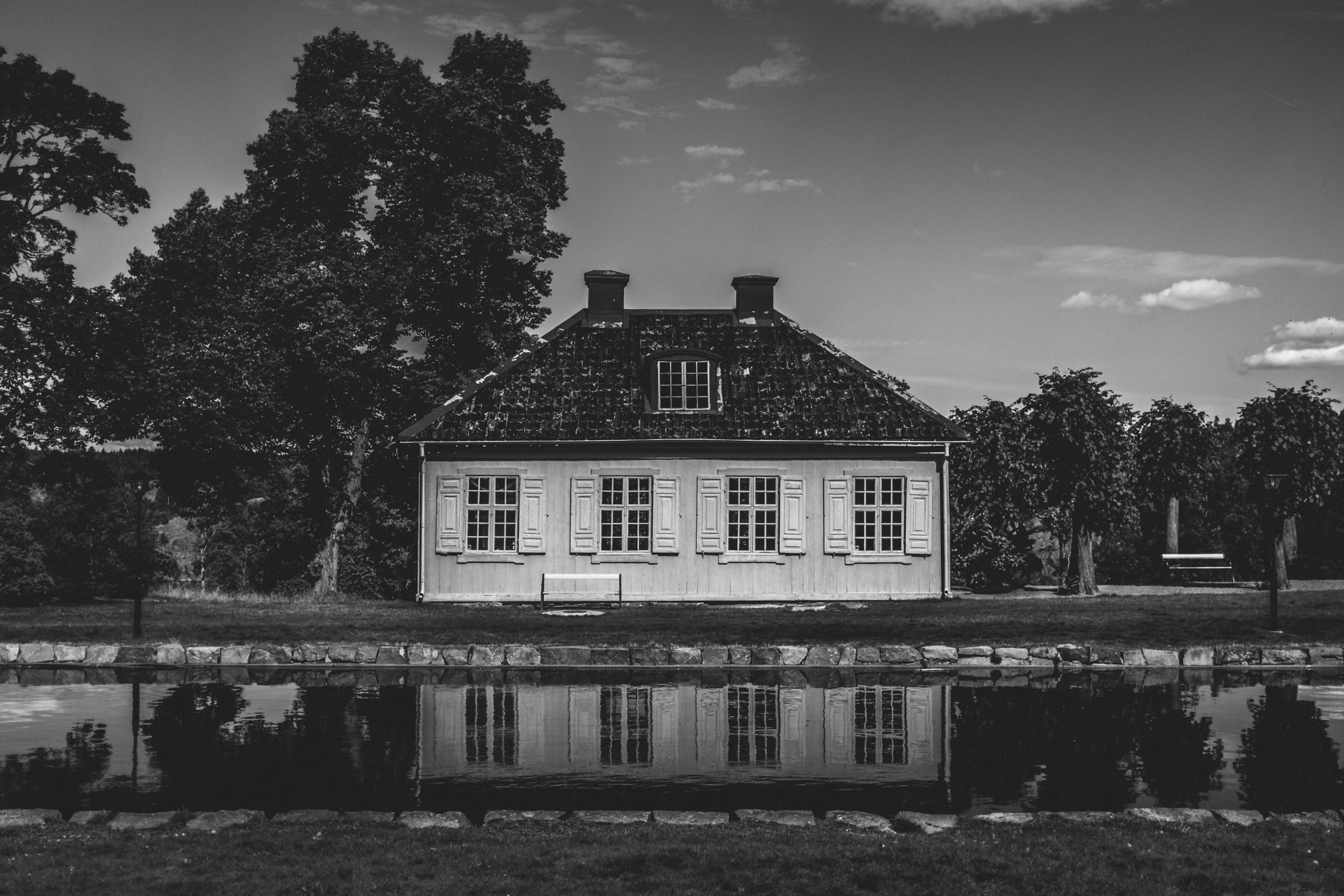 black and white po of a small building and its reflection