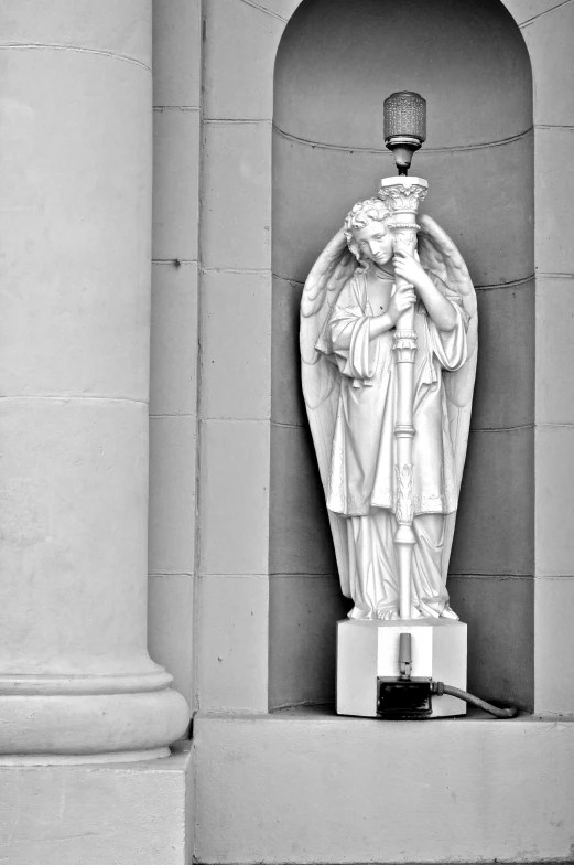 a statue on the side of a large building