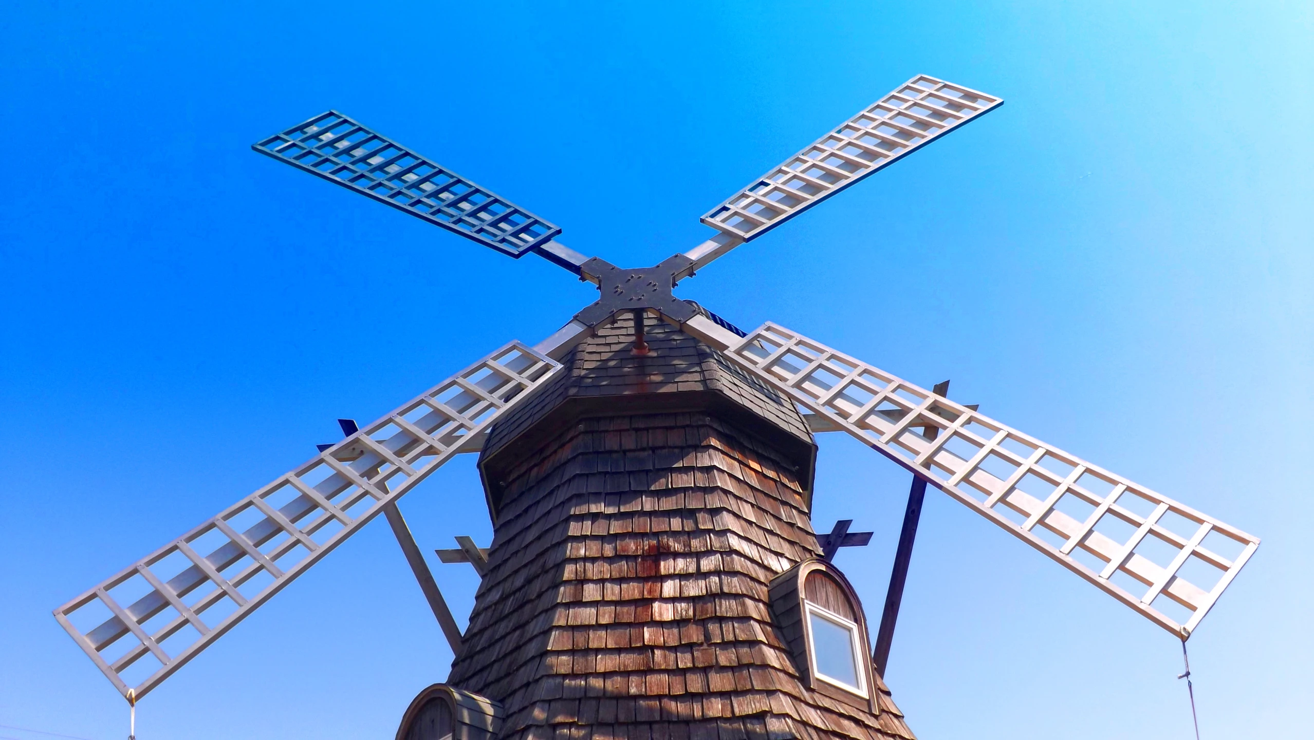 a windmill with multiple blades, with a sky background