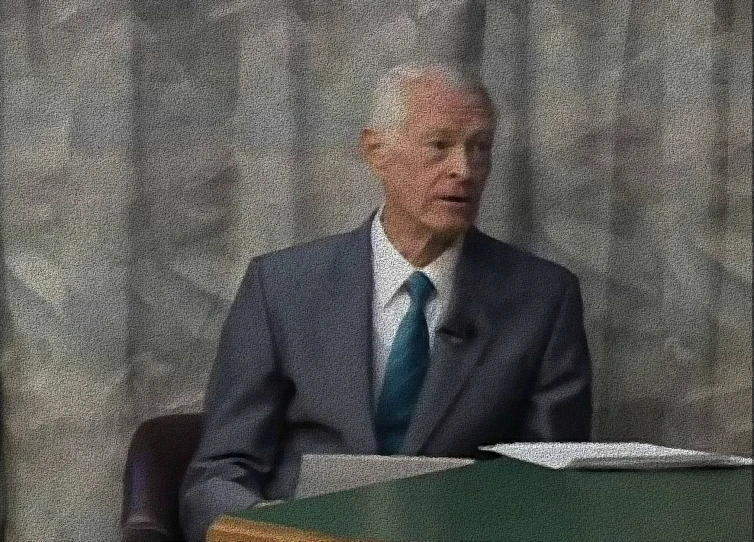 a person sitting in front of a podium on a stage