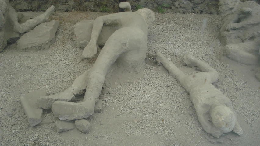 a sand sculpture of a sleeping human laying down