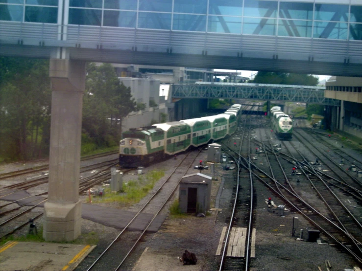 two trains in a train station with lots of tracks