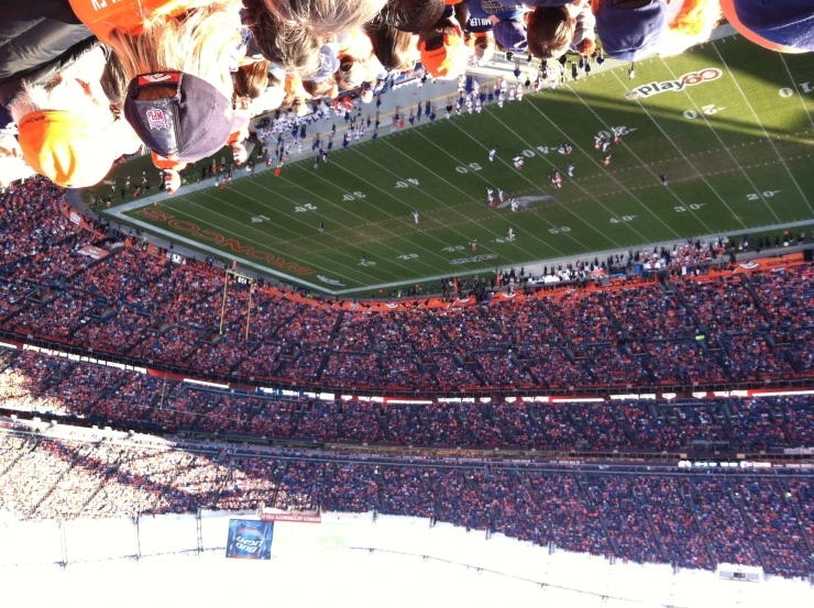 a large crowd of people are at a football game