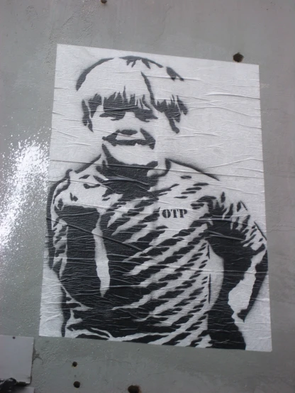 a poster of a boy with a smile is on the side of a building