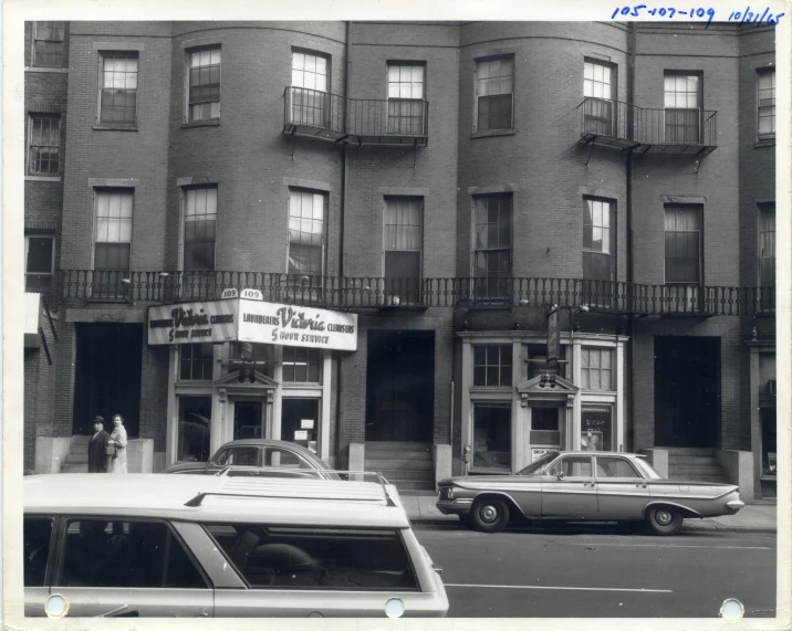 black and white pograph of cars parked on the road