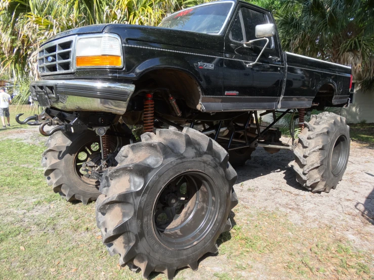 the black pick up truck has four large tires