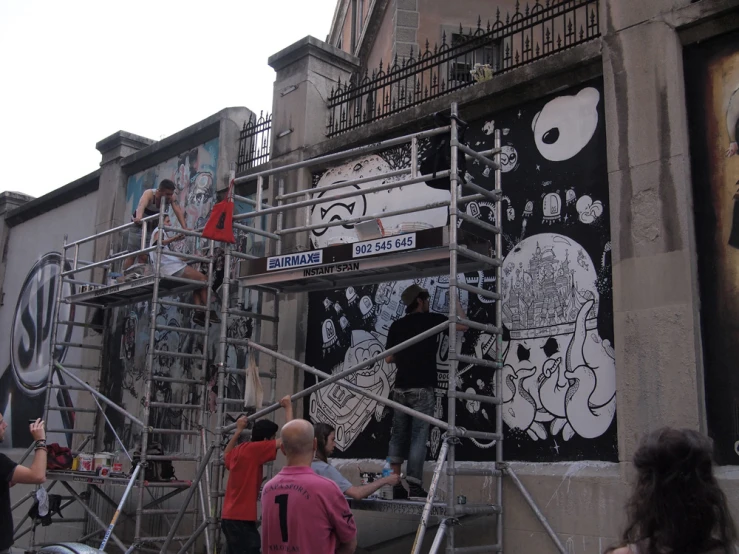 people painting on some art deco wall and steps