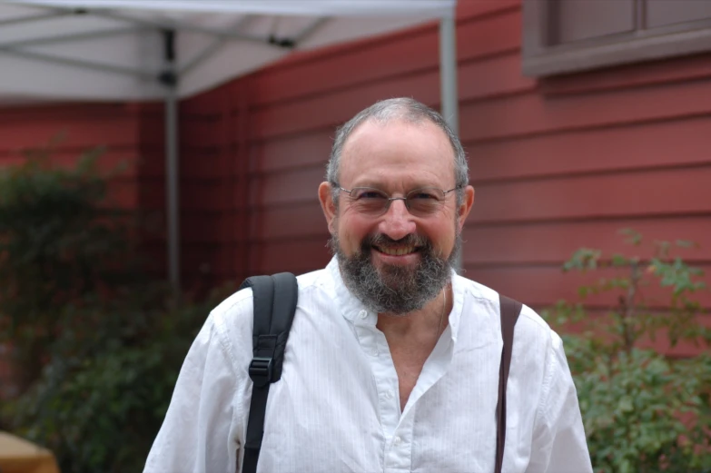 a man with a beard and glasses wearing a black tie