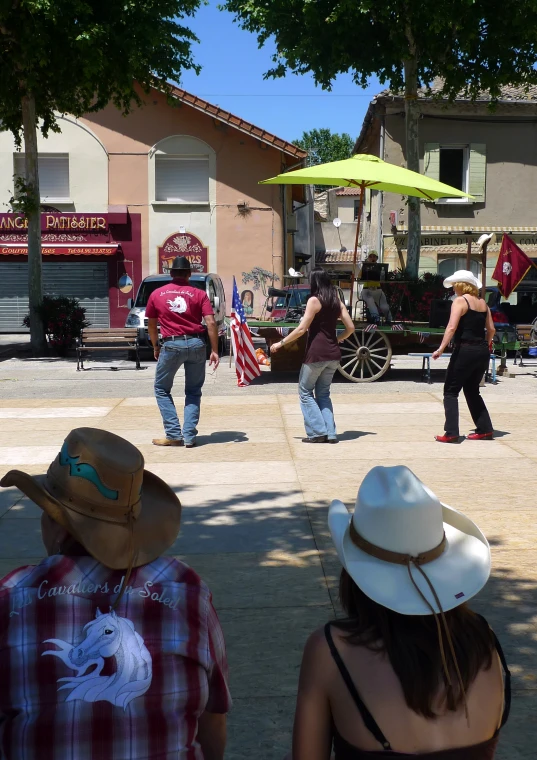 several people are playing around in an open plaza