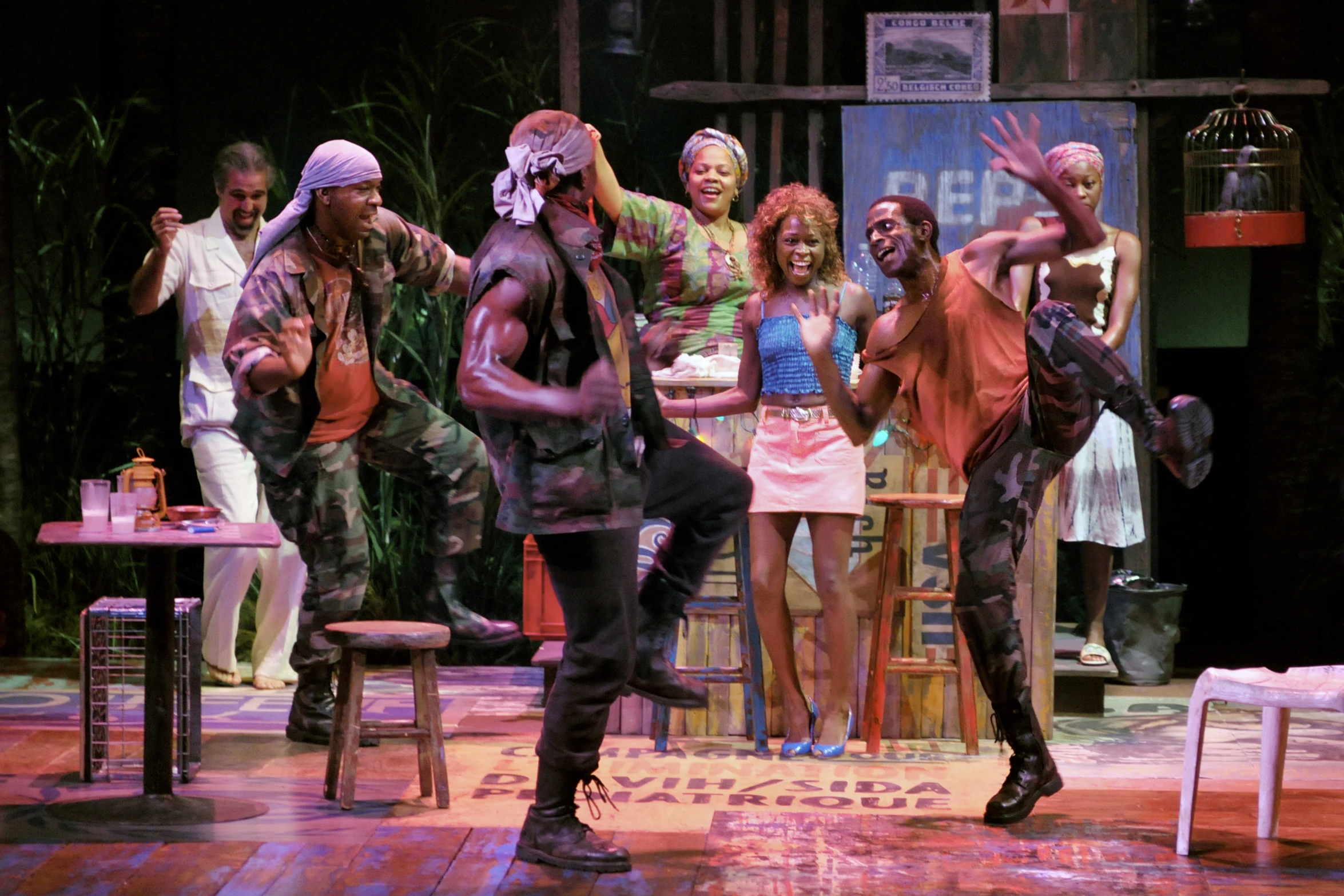 the cast of grease on stage in costume