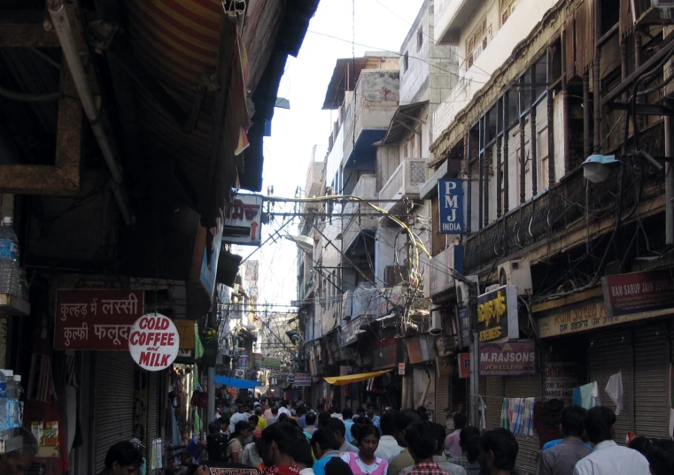 an asian city street filled with people and shops