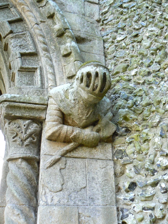 a statue of a person is attached to the side of an outdoor structure