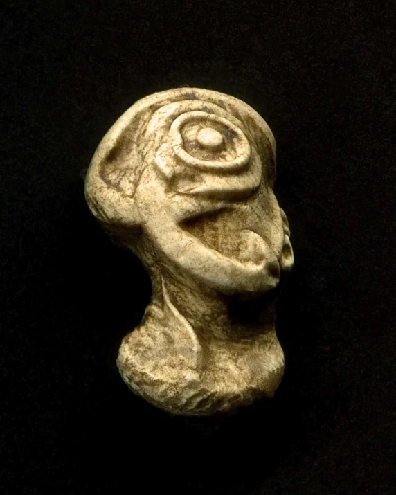 a clay sculpture of a female figure with eyes and hair