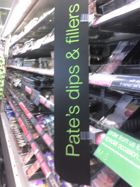 a store shelf displaying a sign that says, please products