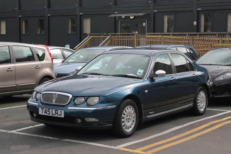 a blue car in a parking space next to a building