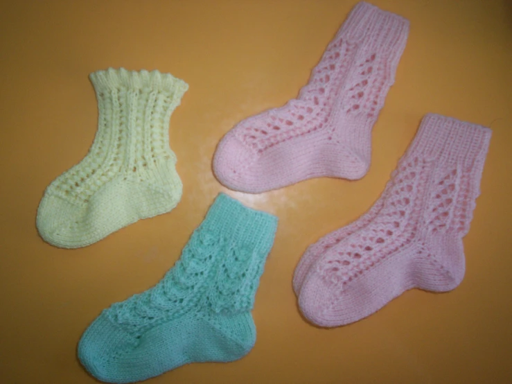 three knitted socks on top of a table