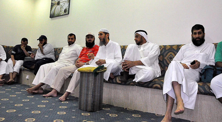 many men in white sitting on the couch