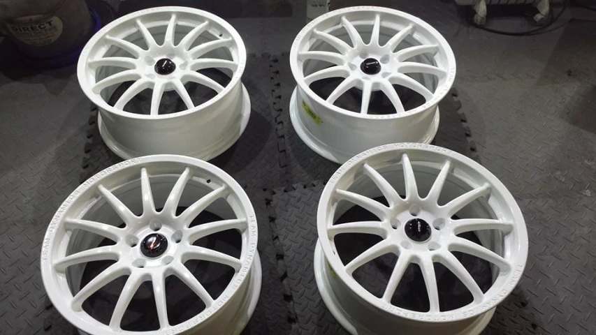 some white wheels are on a table near each other