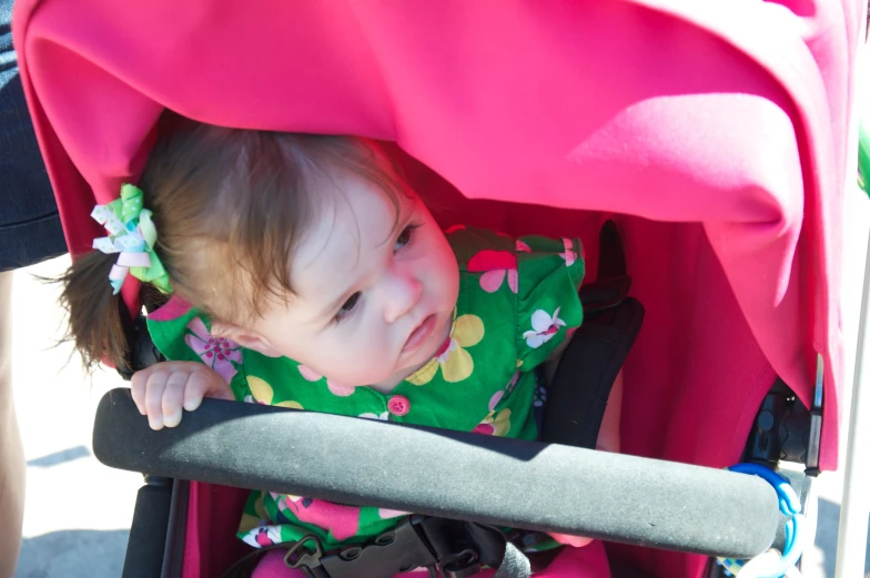 a toddler smiling in her stroller