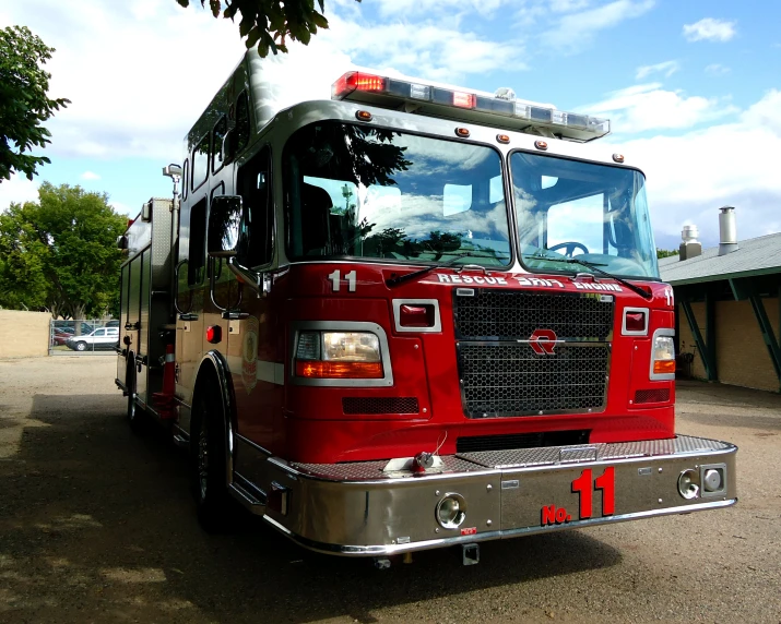 a large red fire truck parked in a parking lot