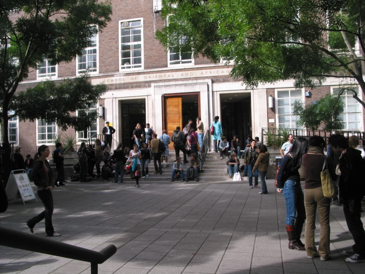 a bunch of people are gathered outside the building