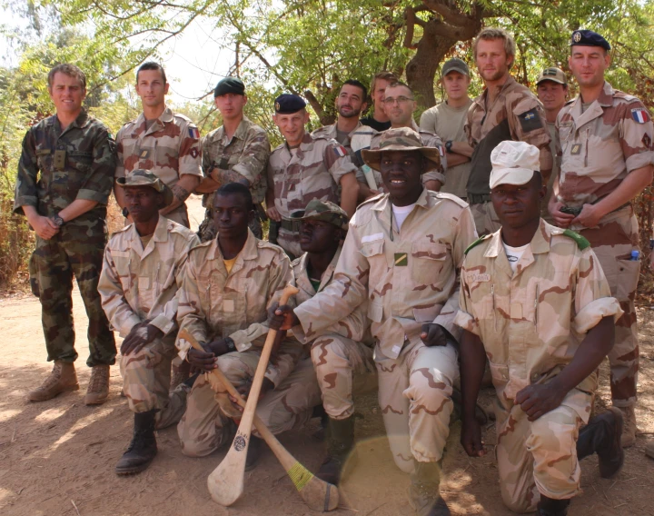 a group of men in army fatigues pose for a po