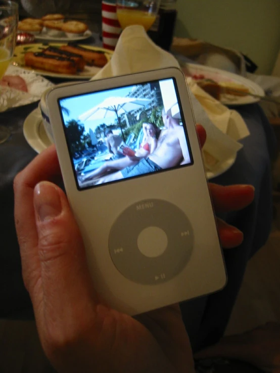 a person holding a ipod with an image on the screen