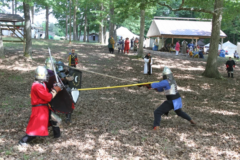 several medieval knight fighters fighting in an open field