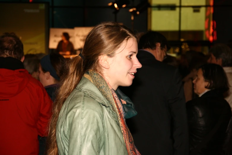 a girl looking away in a crowd of people