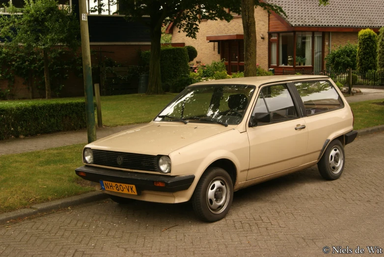 a car is parked on the sidewalk in front of houses