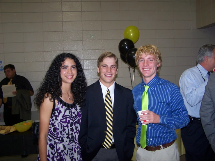 three men and two women wearing ties at an event