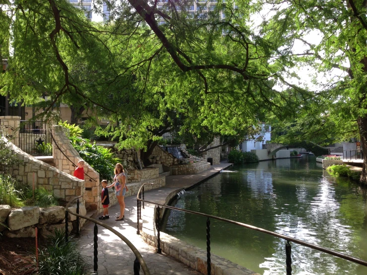 a woman is walking down some steps by the water