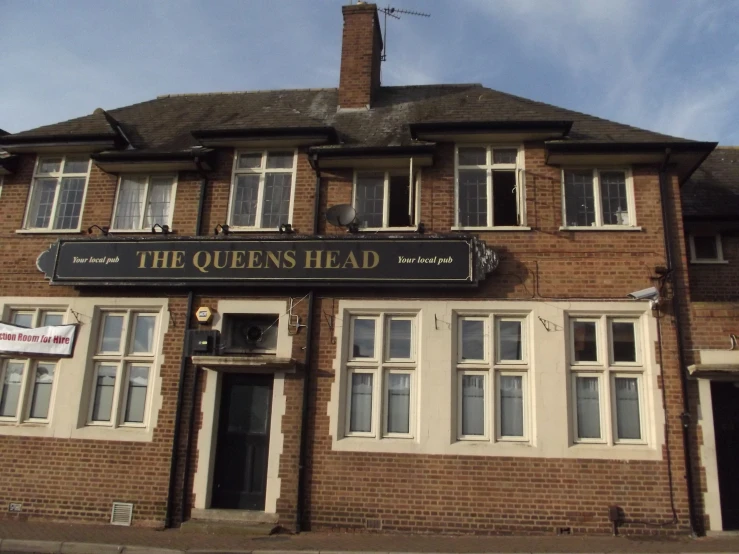 a sign above the front entrance of a red brick building