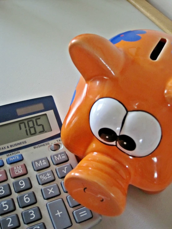 a pig shaped like an orange pig and a calculator